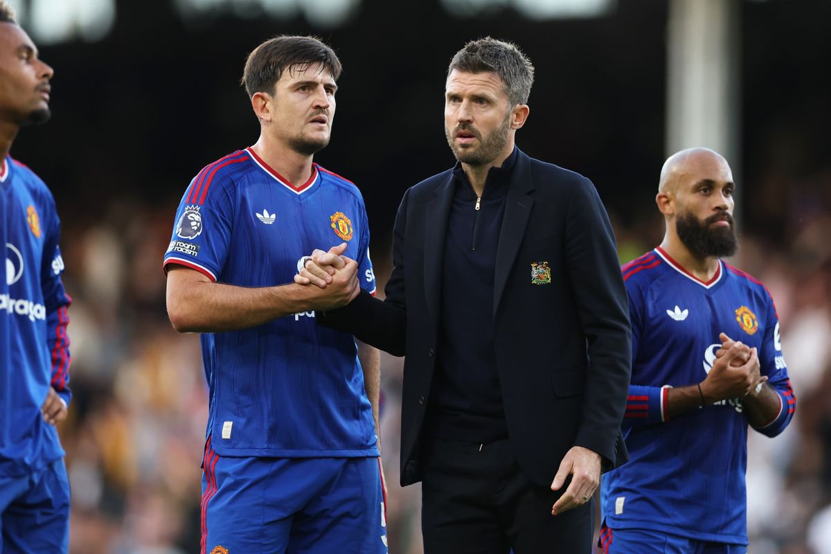Harry Maguire of Manchester United shakes hands with Michael Carrick, manager of Manchester United, after the Premier League match between Fulham and Manchester United at Craven Cottage
