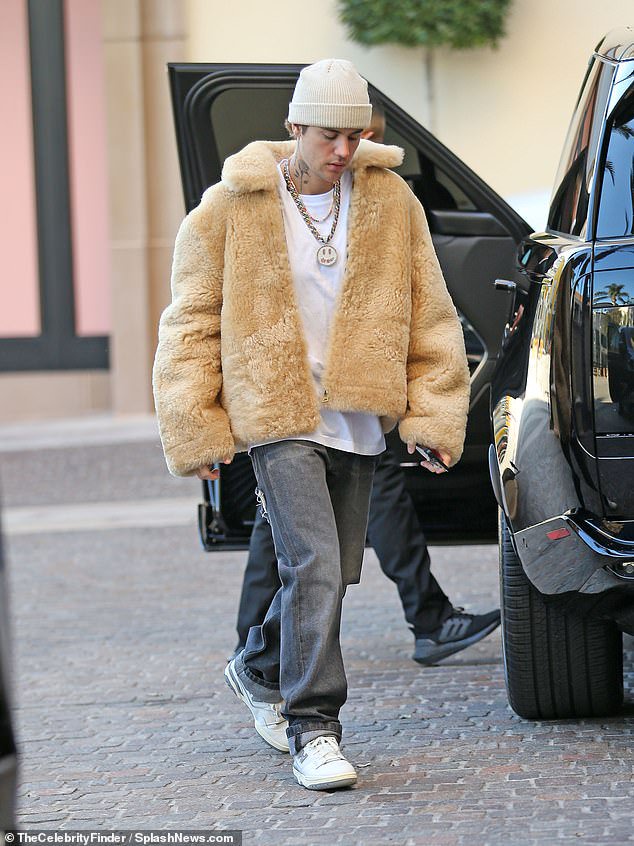 Accessories: Hailey Bieber 's husband added a coordinated vertically ribbed beanie as well as a flashy diamond chain with a large pendant of his Drew House logo