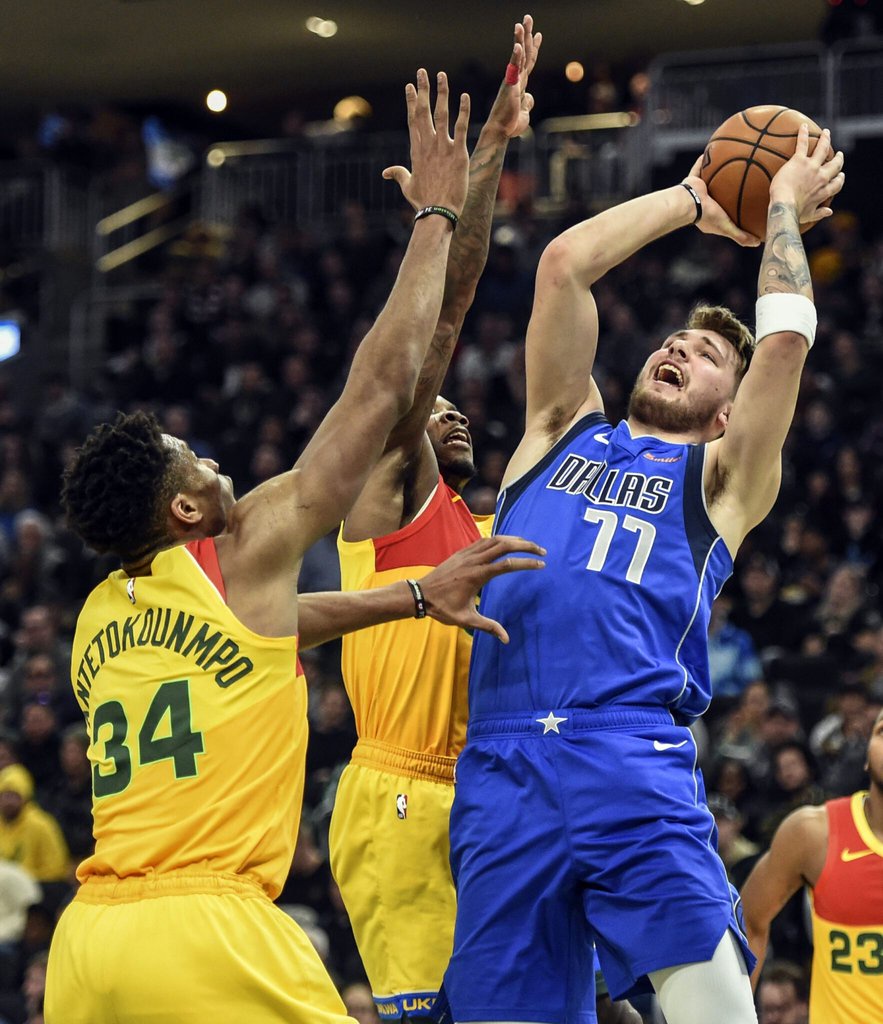 Jan 21, 2019; Milwaukee, WI, USA; Dallas Mavericks forward Luka Doncic (77) takes a shot against Milwaukee Bucks forward Giannis Antetokounmpo (34) in the third quarter at the Fiserv Forum. Mandatory Credit: Benny Sieu-USA TODAY Sports