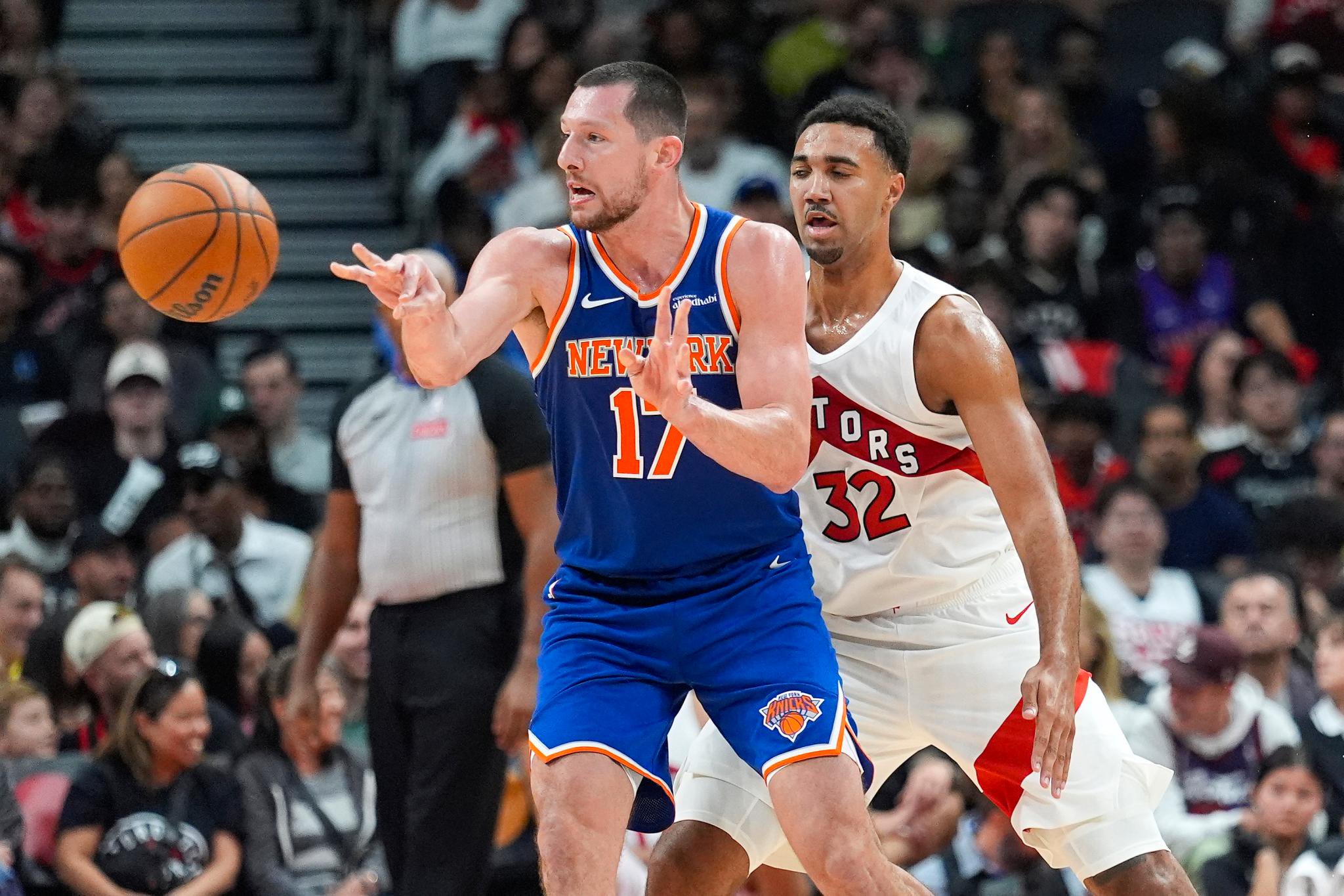 Knicks center Drew Eubanks (17) passes the ball against Toronto Raptors forward Trayce Jackson-Davis (32) during the second half of a game at Scotiabank Arena in Toronto, Ontario, Tuesday, Oct. 13, 2026.