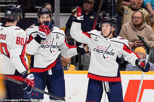 Washington Capitals defenseman Cole Hutson, right, celebrates his goal with right wing Tom Wilson (43) and center Pierre-Luc Dubois (80) during the first period of an NHL hockey game against the Nashville Predators, Thursday, Oct. 29, 2026, in Nashville, Tenn. (AP Photo/George Walker IV)