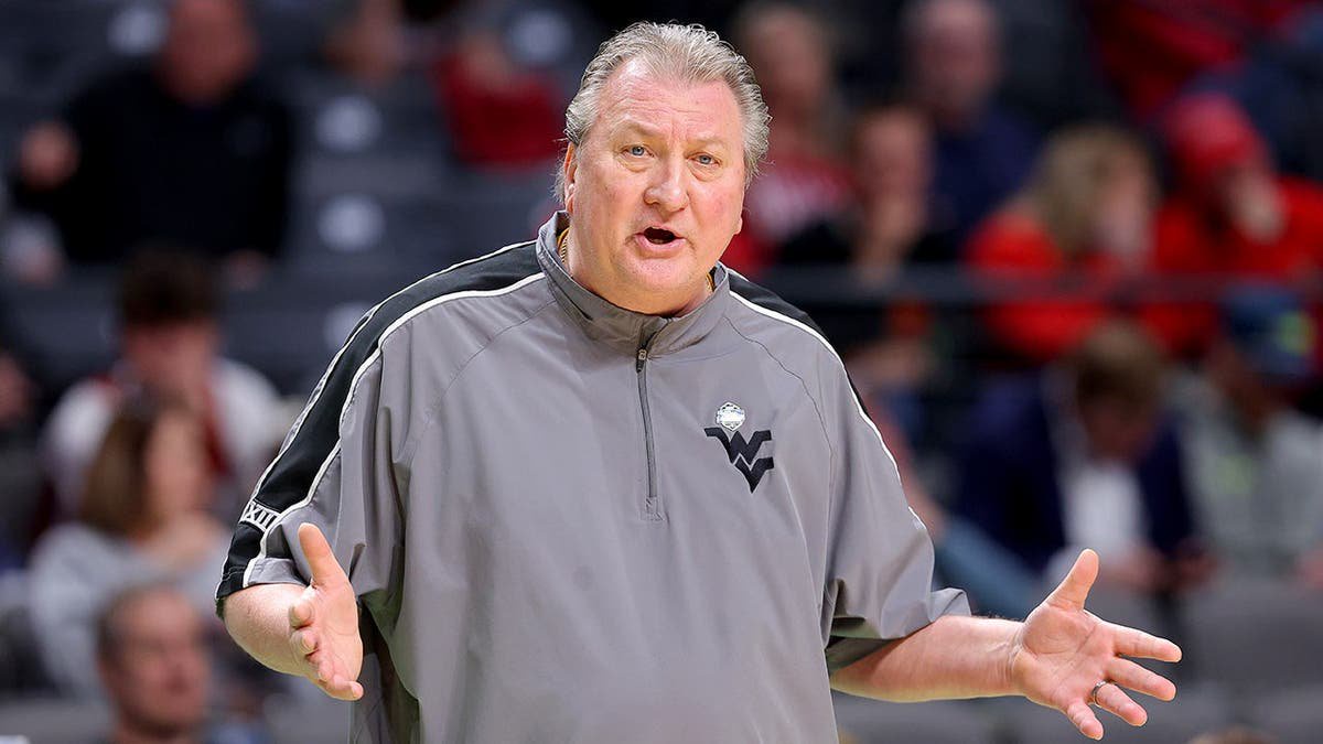 Bob Huggins reacts on the sideline during a basketball game.