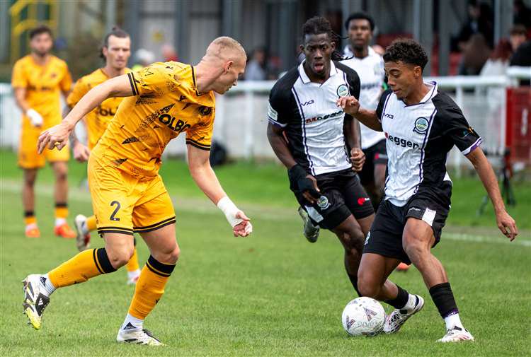 Luke Baptiste, of Dover Athletic, on the attack against Dorking Wanderers defender Brennan Camp in the FA Cup last Saturday. Picture: Cadan Boynton (@cadanboyntonphotography)