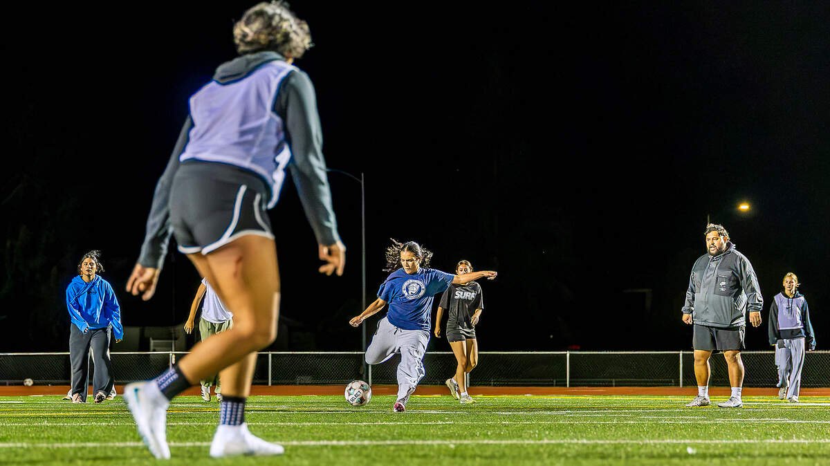Chiawana sophomore defender Milania Sanchez (5), center, kicks the ball during a team practice Monday, Oct. 26, 2026, in Pasco, Wash., as Riverhawks head coach Sam Nunez, right, watches. Chiawana finished undefeated in Mid-Columbia Conference play at 9-0 and hosts Ferris at 6 p.m. Tuesday in the opening round of the District 6 4A girls soccer tournament.