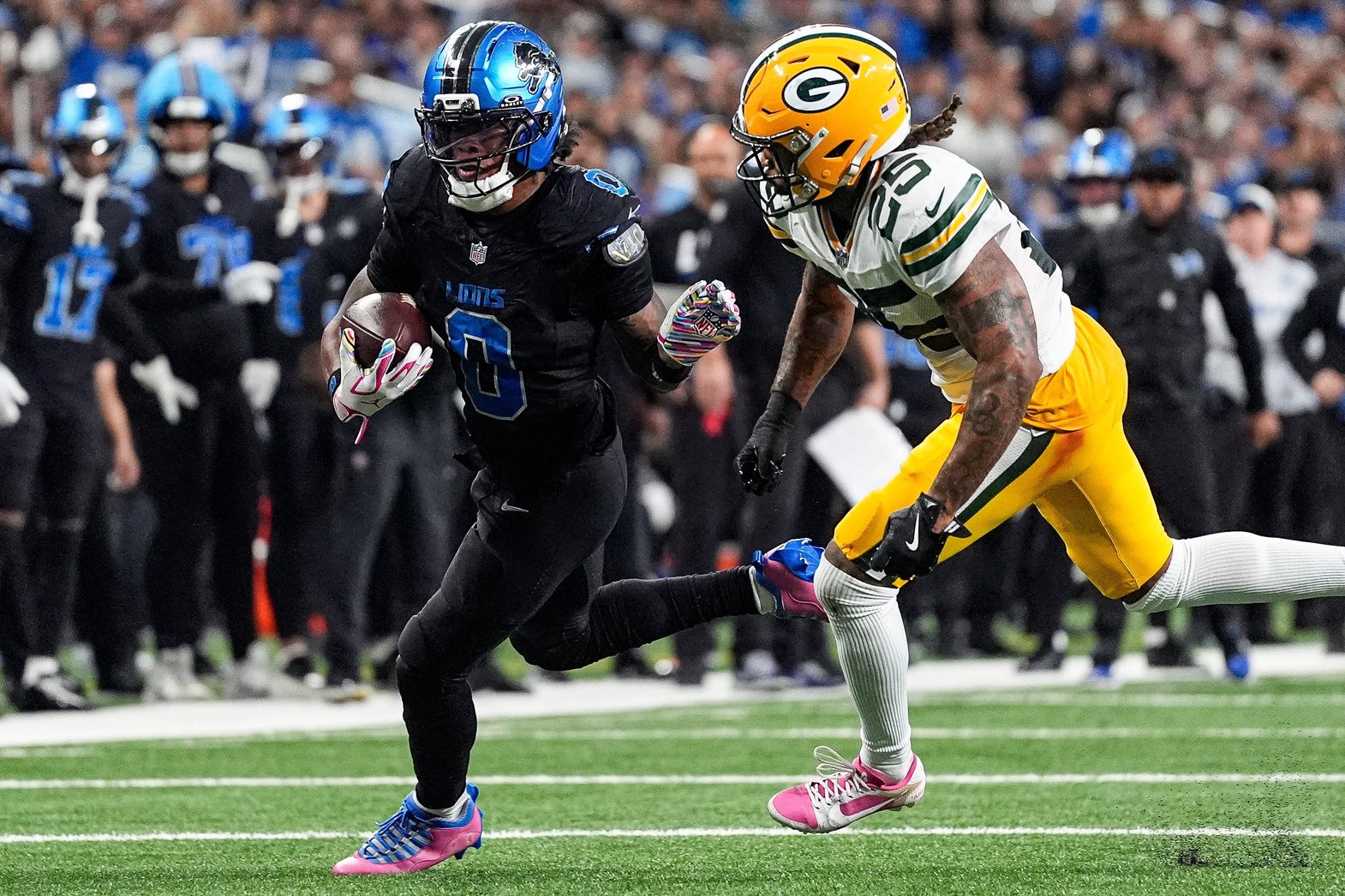 Detroit Lions running back Jahmyr Gibbs (0) runs against Green Bay Packers cornerback Keisean Nixon (25) during the second half at Ford Field in Detroit on Sunday, Oct. 25, 2026.