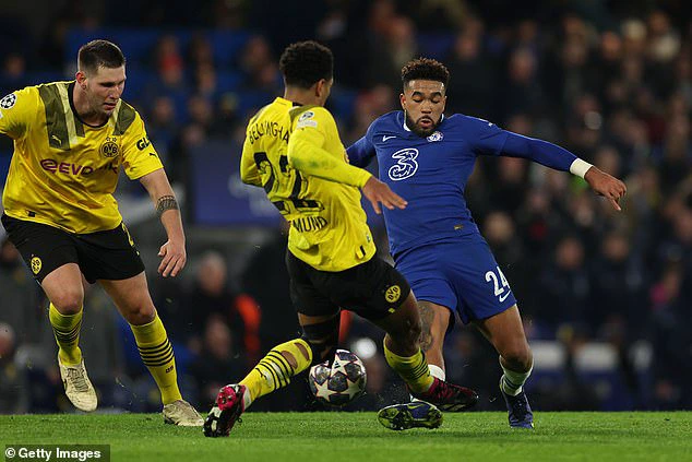 Bellingham had a frustrating night at Stamford Bridge that ended with his dangerous challenge on his England team-mate James (R)