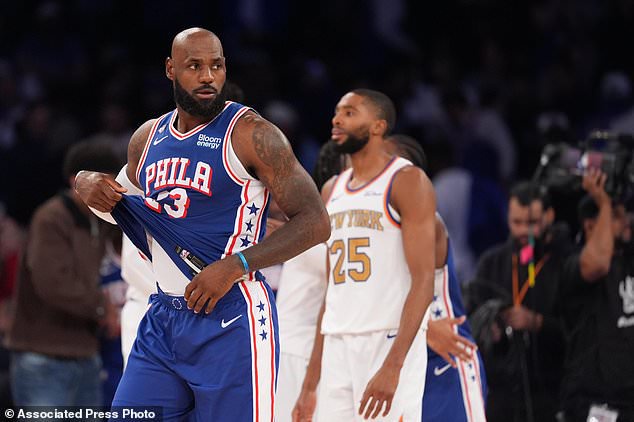 Philadelphia 76ers forward LeBron James, left, passes New York Knicks guard Mikal Bridges after the 76ers defeated the Knicks 106-100 in an NBA basketball game Tuesday, Oct. 20, 2026, in New York. (AP Photo/Frank Franklin II)