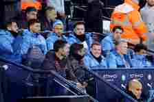 Sergio Gomez and Erling Haaland of Manchester City look on from the substitutes bench during the Premier League match between Manchester City and B...