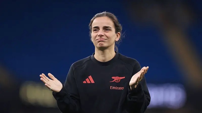 Renee Slegers, wearing a black jumper, holds to hands up in frustration