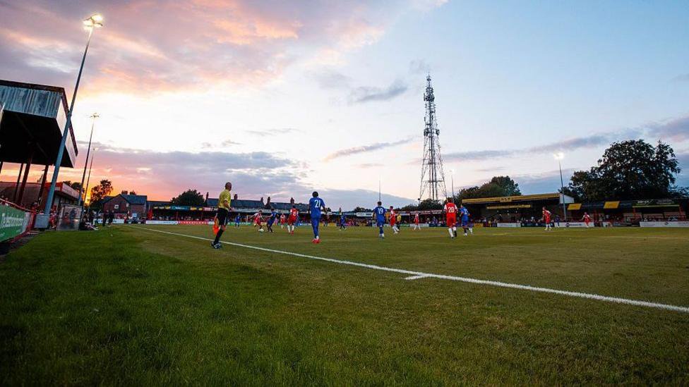 Moss Lane, Altrincham stages a pre-season night game against Manchester United Under-21s (31 July 2026)  