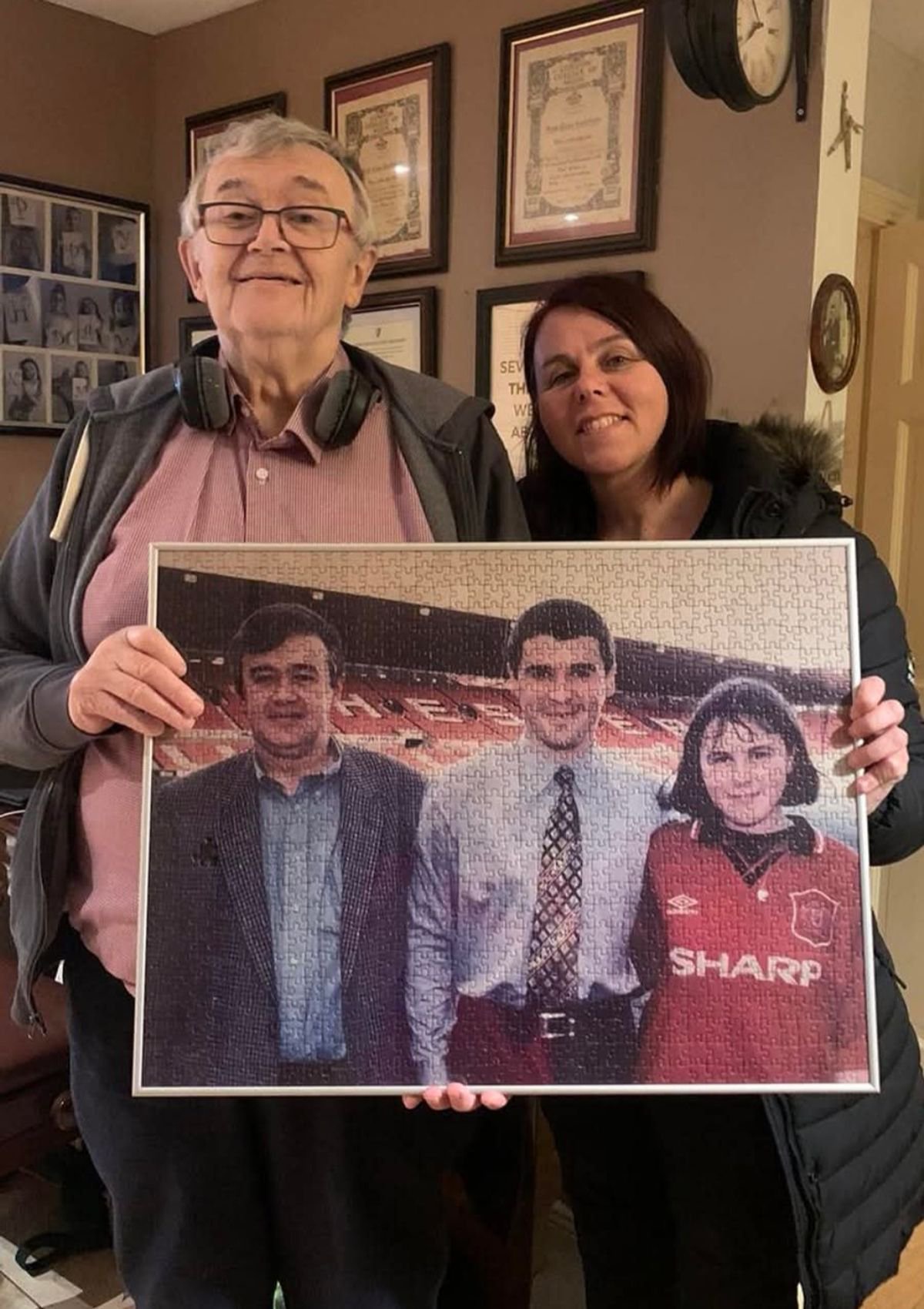 Claire holding the jigsaw with her late father William