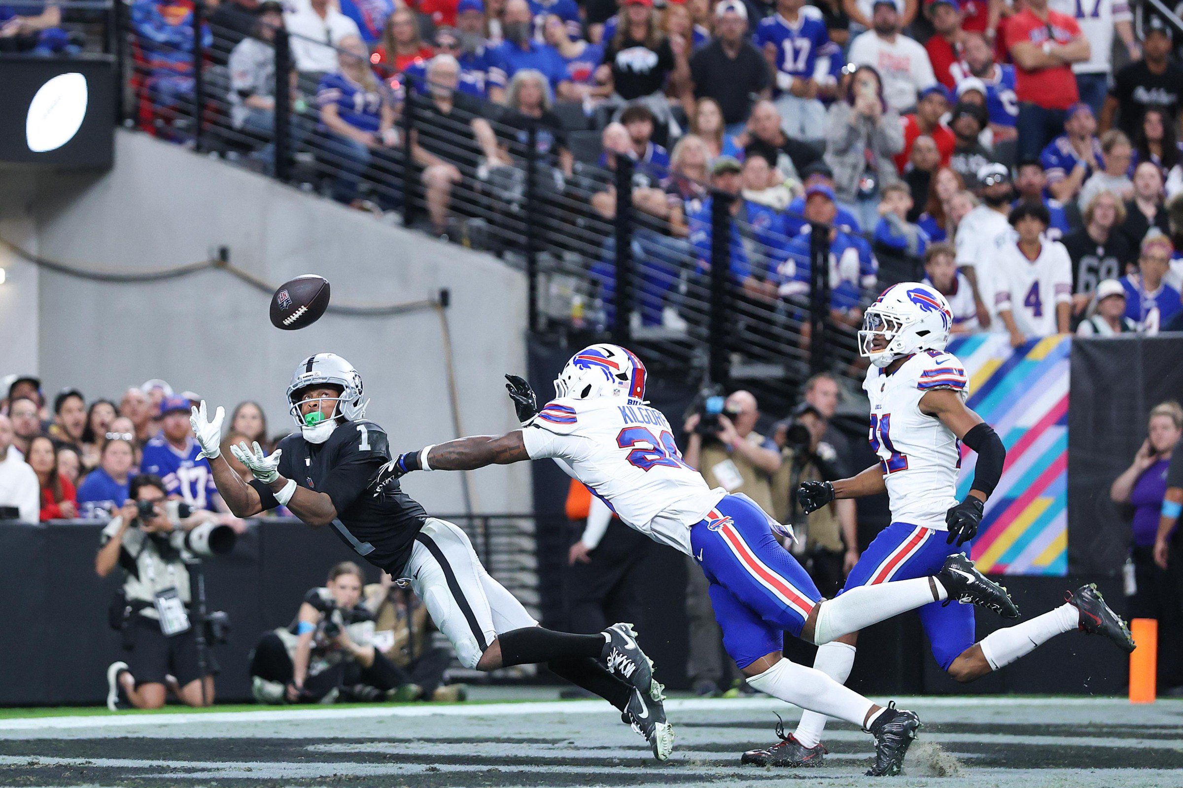 LAS VEGAS, NEVADA - OCTOBER 18: Tre Tucker #1 of the Las Vegas Raiders catches a touchdown pass against Jalon Kilgore #29 and Davison Igbinosun #21 of the Buffalo Bills in the fourth quarter of a game at Allegiant Stadium on October 18, 2026 in Las Vegas, Nevada. (Photo by Christian Petersen/Getty Images)