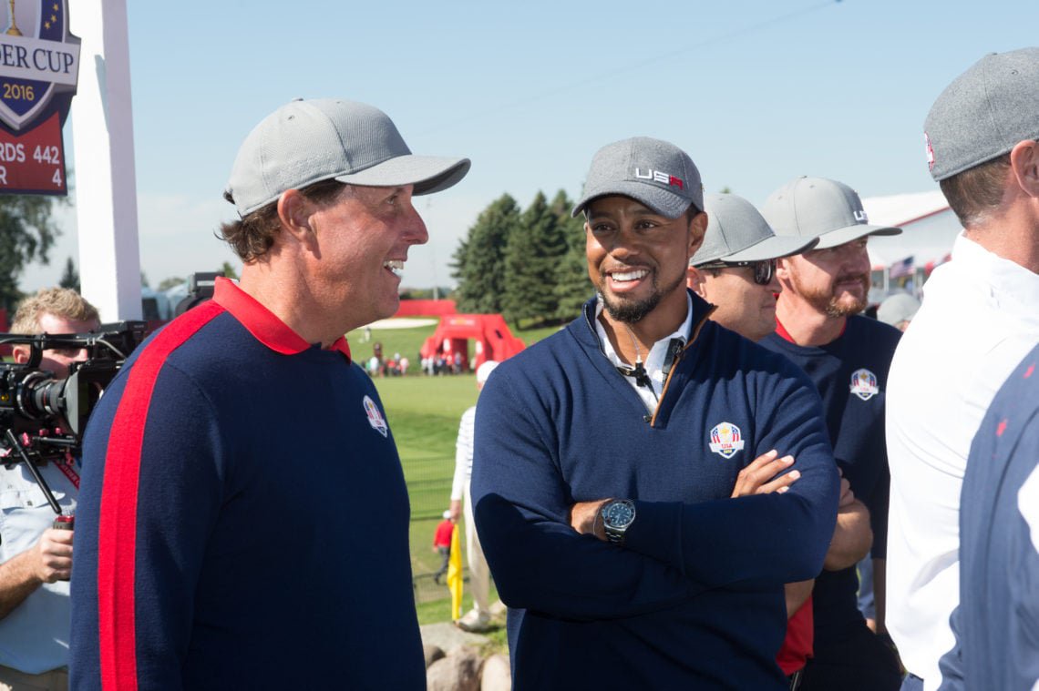 The United States Vice Captain, Tiger Woods and Phil Mickelson of the United States talk on the first tee during the fourball matches for the 41st Ryder Cup
