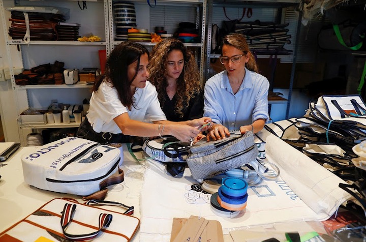 Sisters Carla, Ornella and Mora Basilotta discuss the design of a handbag.
