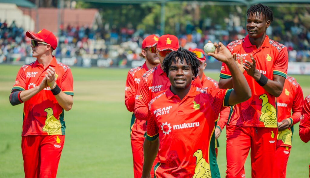 Newman Nyamhuri leads Zimbabwe off the field after claiming his maiden T20I fifer PIC Zimbabwe Cricket