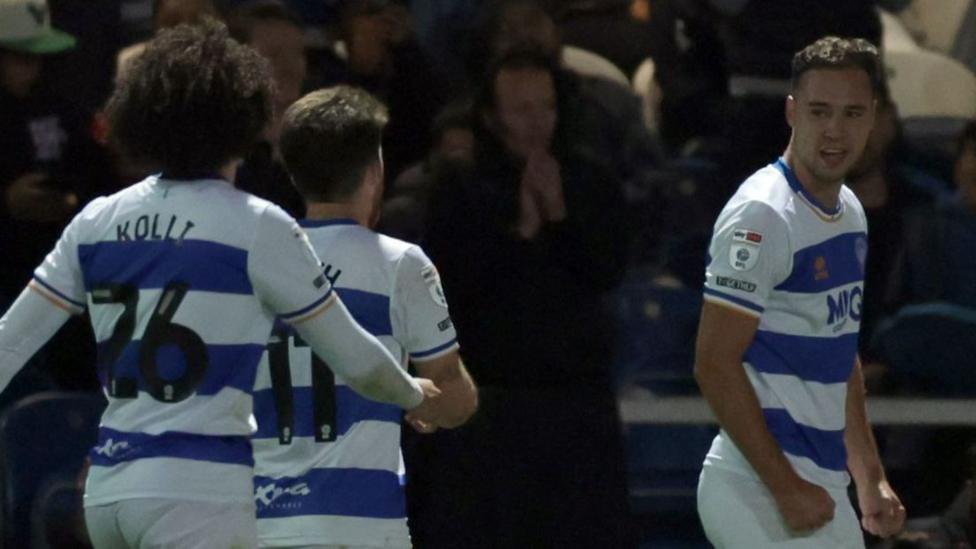 Harvey Vale (right) celebrates scoring against Derby County as two of his QPR team-mates run towards him.