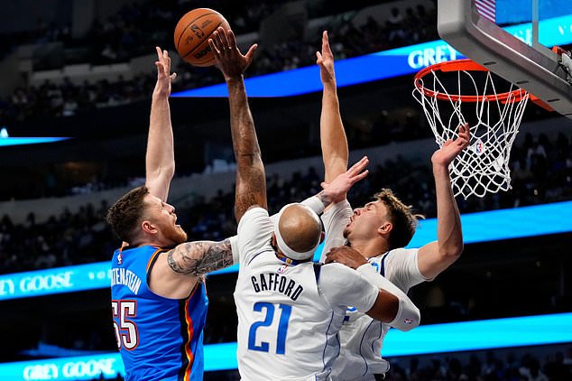 Oklahoma City Thunder center Isaiah Hartenstein (55) shoots over Dallas Mavericks forward Daniel Gafford (21) and forward Cooper Flagg during the first half of an NBA basketball game Wednesday, Oct. 28, 2026, in Dallas. (AP Photo/Jeffrey McWhorter)