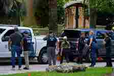 <p>Law enforcement agents stand at the entrance to a property belonging to rapper Sean ‘Diddy’ Combs (Rebecca Blackwell/AP/PA)</p>