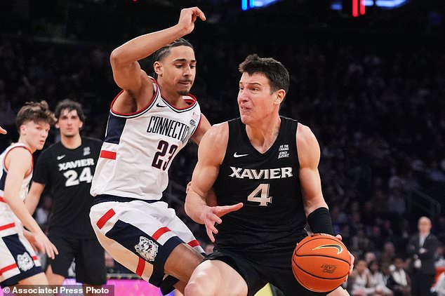 FILE - Xavier's Filip Borovicanin, right, drives on UConn's Jayden Ross (23) during second half of an NCAA college basketball game in the quarterfinals of the Big East basketball tournament Thursday, March 12, 2026, in New York. (AP Photo/Frank Franklin II, File)