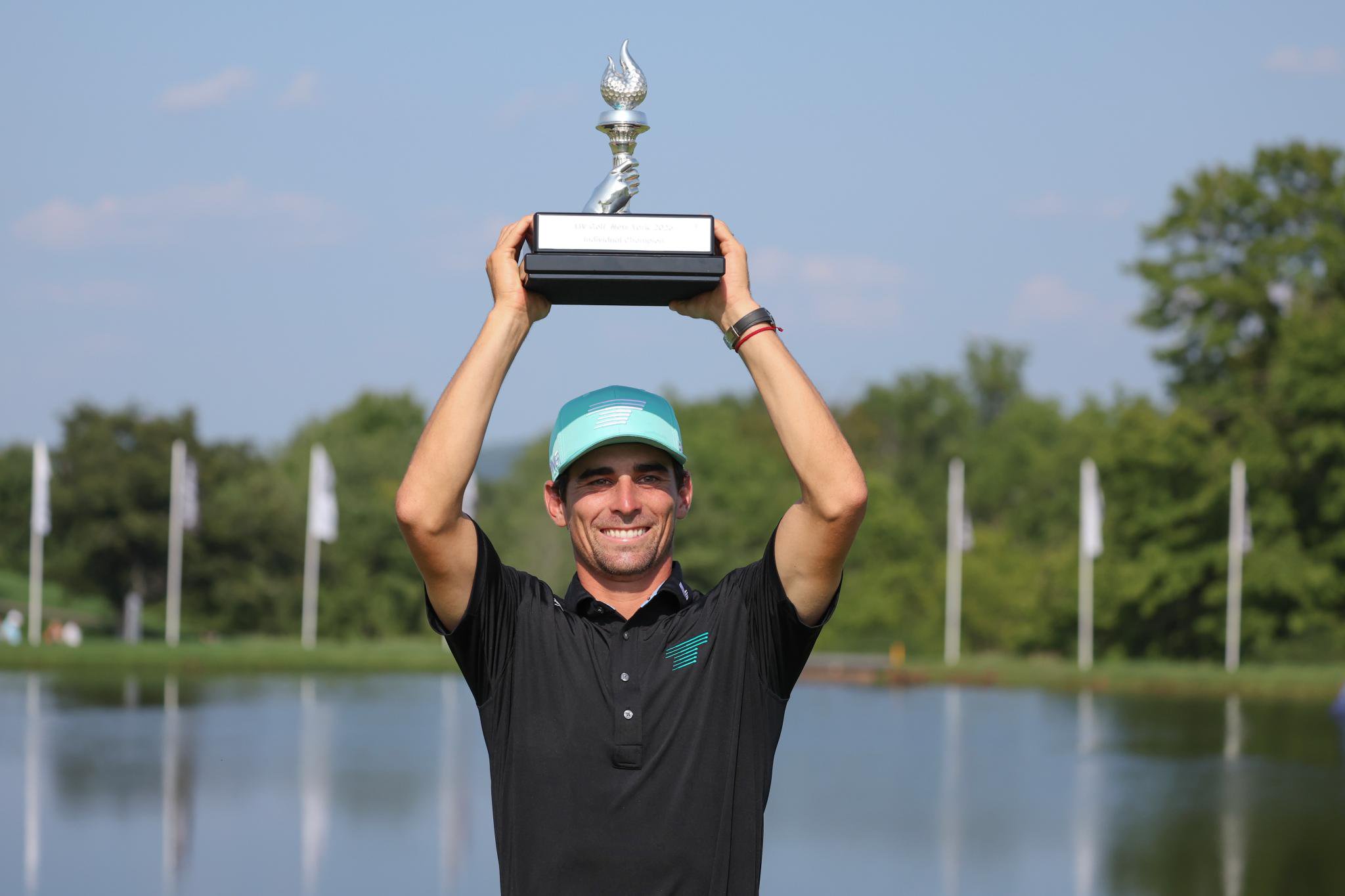 Joaquin Niemann hoists the trophy after winning the LIV Golf New York title.