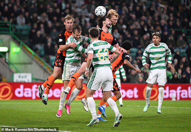 Liam Scales rises highest to head home the equaliser for Celtic