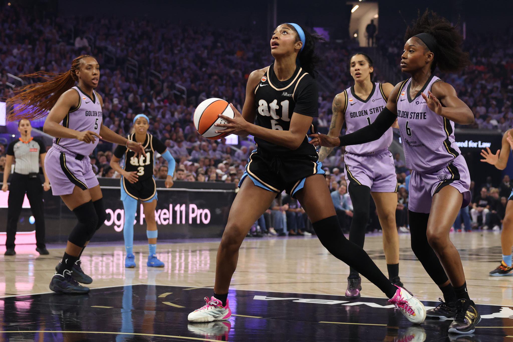 Angel Reese #5 of the Atlanta Dream looks to shoot the ball past Kaila Charles #6 of the Golden State Valkyries during the WNBA Finals.