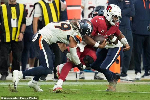 Arizona Cardinals quarterback Jacoby Brissett (7) is tackled by Denver Broncos linebacker Alex Singleton (49) and cornerback Ja'quan McMillian (29) during the second half of an NFL football game in Glendale, Ariz., Sunday, Oct. 25, 2026. (AP Photo/Ross D. Franklin)