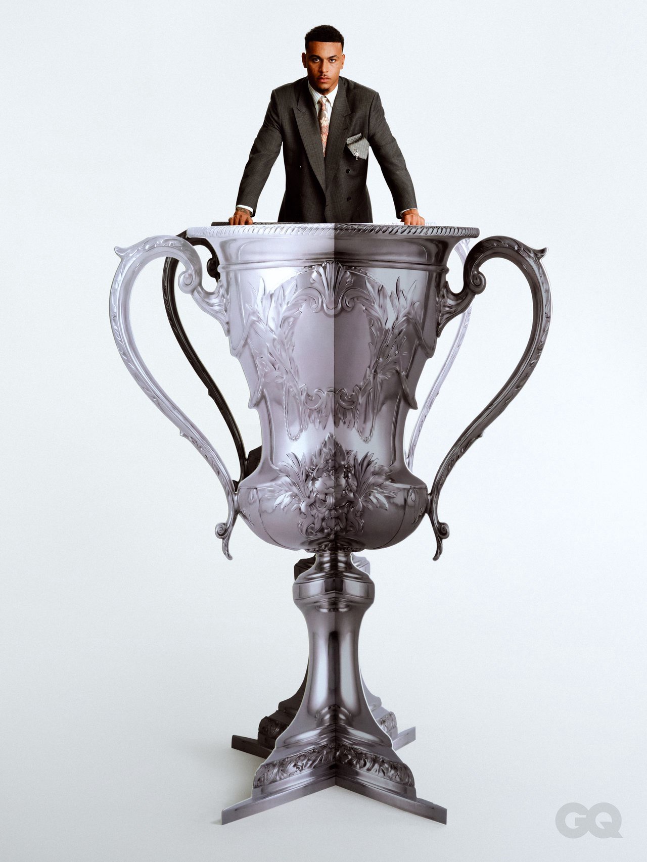 Image may contain Clothing Formal Wear Suit Coat Trophy Festival and Hanukkah Menorah