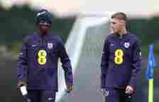 Kobbie Mainoo and Cole Palmer of England talk during a training session at Spa & Golf Resort Weimarer Land on July 01, 2024 in Blankenhain, Ger...