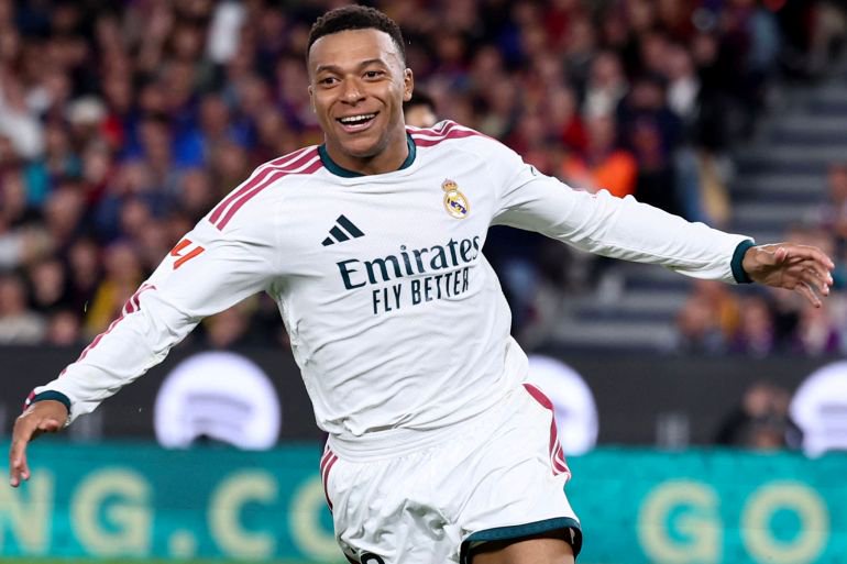 Real Madrid's French forward #10 Kylian Mbappe celebrates scoring his team's second goal during the Spanish league football match between FC Barcelona and Real Madrid CF at Camp Nou Stadium in Barcelona on October 25, 2026. (Photo by Josep LAGO / AFP)
