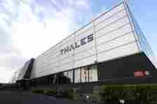 An exterior view of a Thales premises, with 'Thales' written on blue on a white background