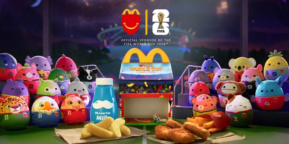 Fast food meal with colorful plush toys promoting FIFA World Cup 2026 and branded packaging.