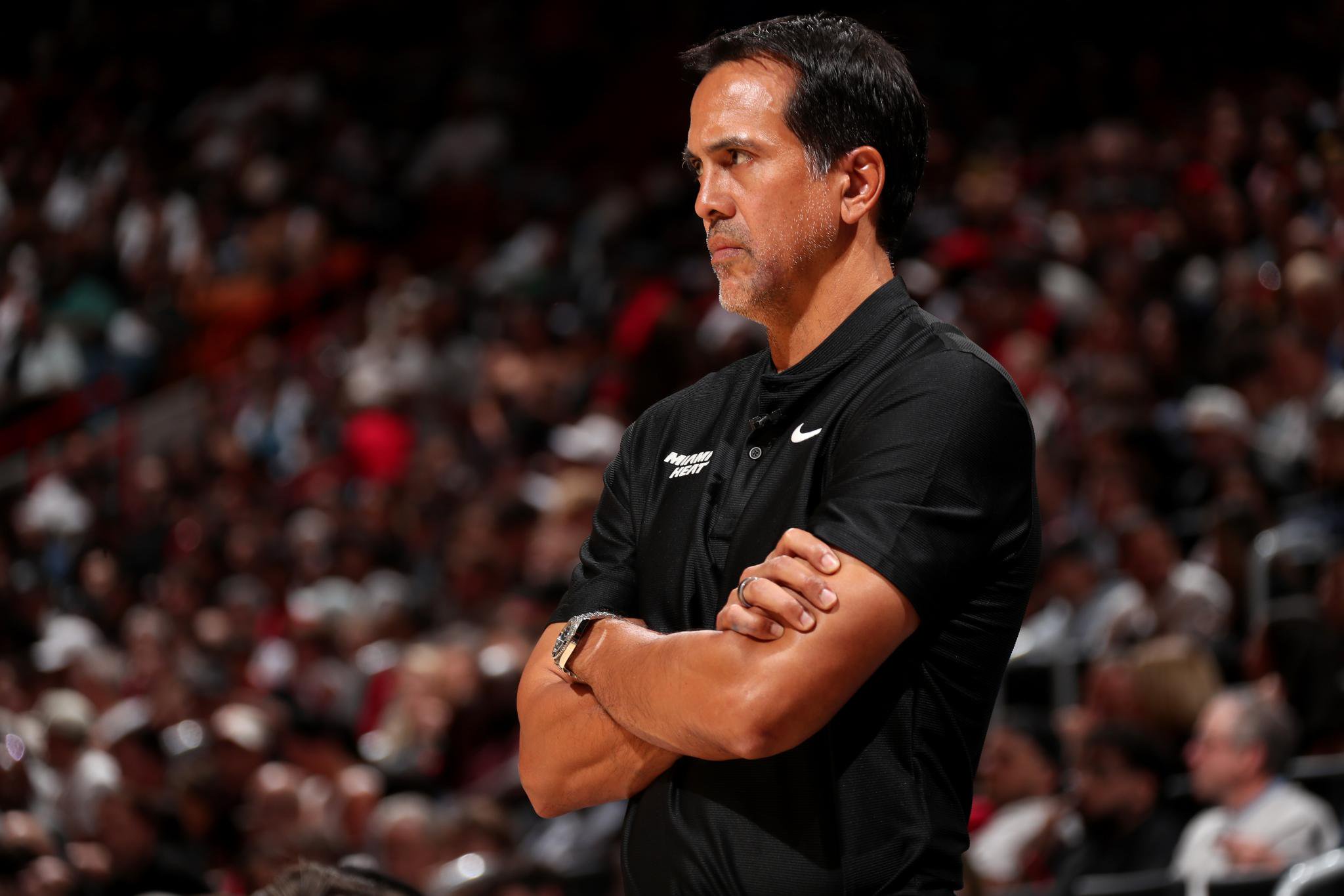 Miami Heat head coach Erik Spoelstra watches the game with his arms crossed.