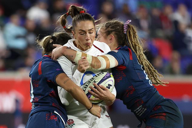 United States' Nina Mason, left, and Bella Vogel, right, tackle England's Holly Aitchison, center, during the second half of an international women's rugby match during the WXV Global Series, Friday, Oct. 30, 2026, in Harrison, N.J. (AP Photo/Pamela Smith)