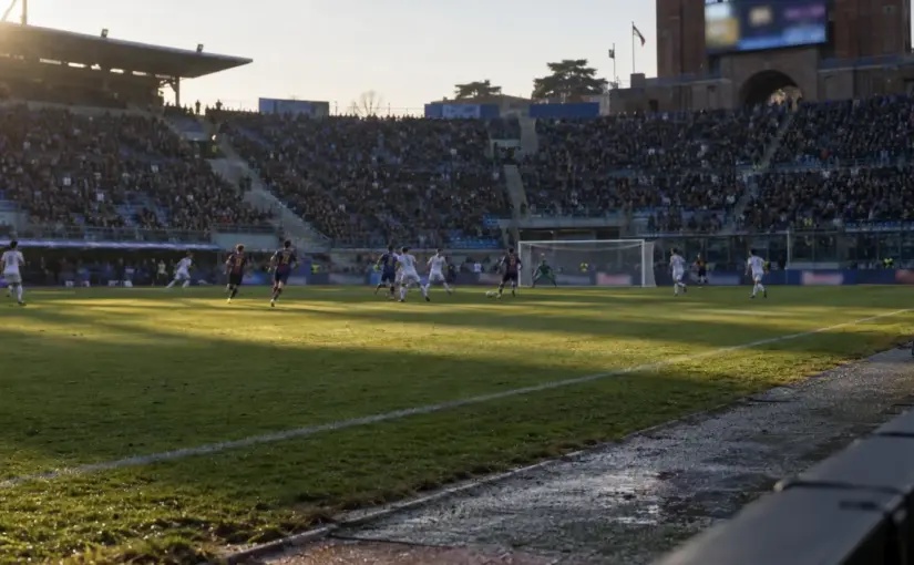 Distant players contest a Serie A match at Bologna's Dall'Ara stadium during Inter's comeback win.