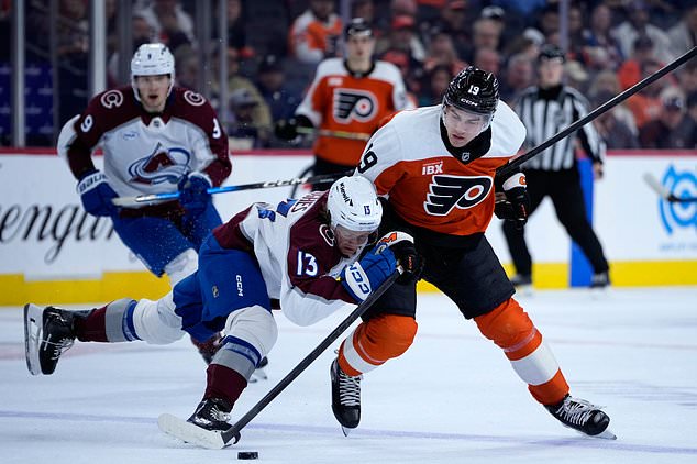 Colorado Avalanche's T.J. Hughes (13) collides with Philadelphia Flyers' Hunter McDonald (19) during the first period of an NHL hockey game Monday, Oct. 19, 2026, in Philadelphia. (AP Photo/Matt Slocum)