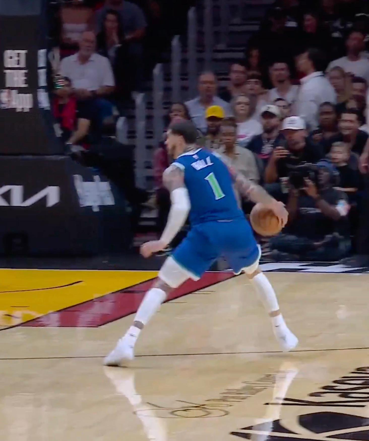 LaMelo Bell dribbling the ball on the court.