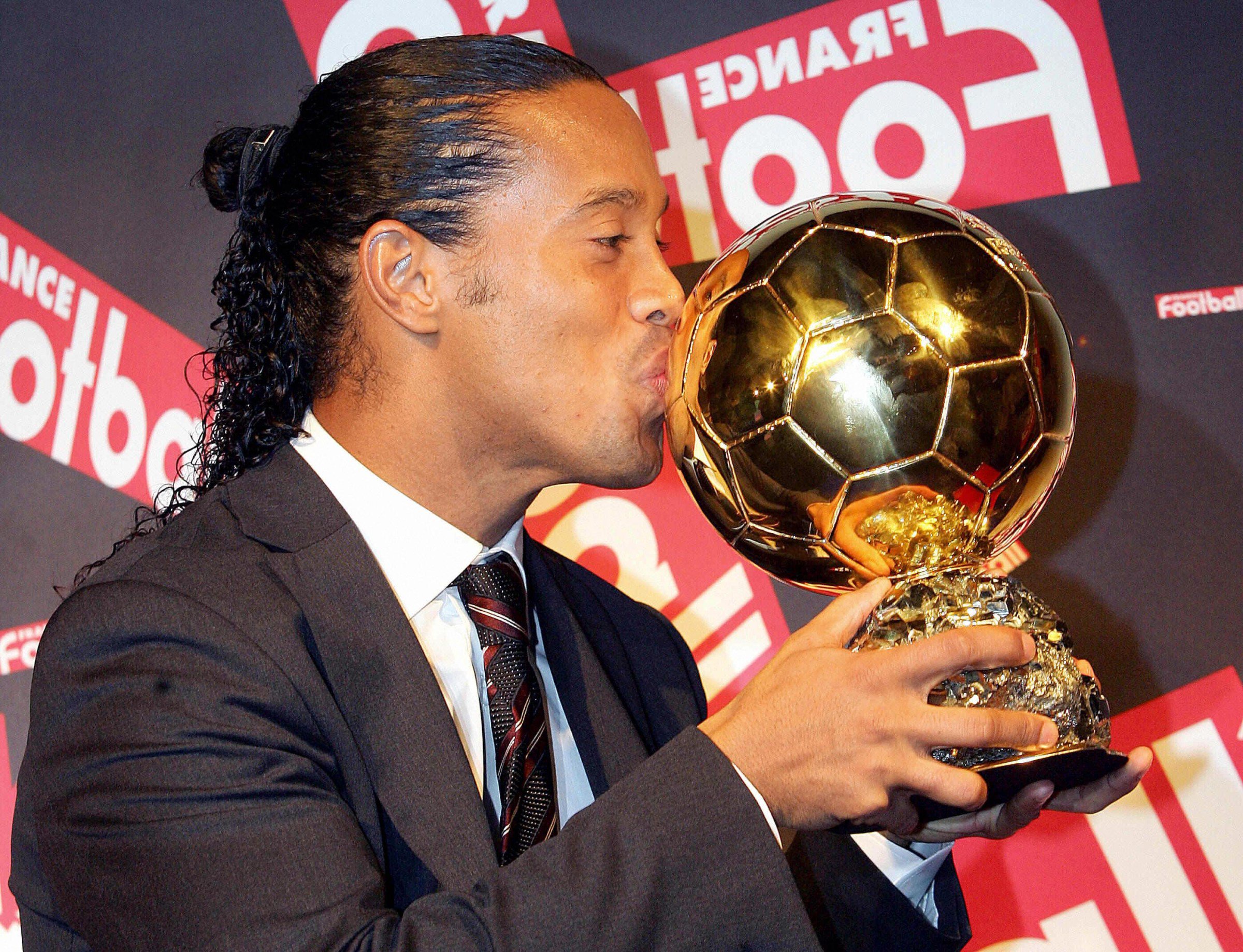 Paris, FRANCE: ATTENTION EMBARGO - DO NOT USE BEFORE 1930GMT - DO NOT USE BEFORE 1930GMT Brazilian Barcelona midfielder Ronaldinho poses with his trophy after being awarded as 50th Ballon d’Or (Golden Ball), for best football player of the year, 28 November 2005 in Paris. Ronaldinho becomes the third Brazilian to win the award after compatriots Ronaldo in 1997 and 2002, and Rivaldo in 1999. AFP PHOTO FRANCK FIFE (Photo credit should read FRANCK FIFE/AFP via Getty Images)