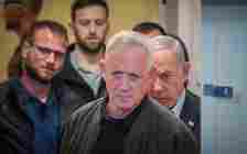 Minister Benny Gantz (center) and Prime Minister Benjamin Netanyahu (right) arrive for a press conference at the Defense Ministry, in Tel Aviv, December 16, 2023. (Noam Revkin Fenton/Flash90)