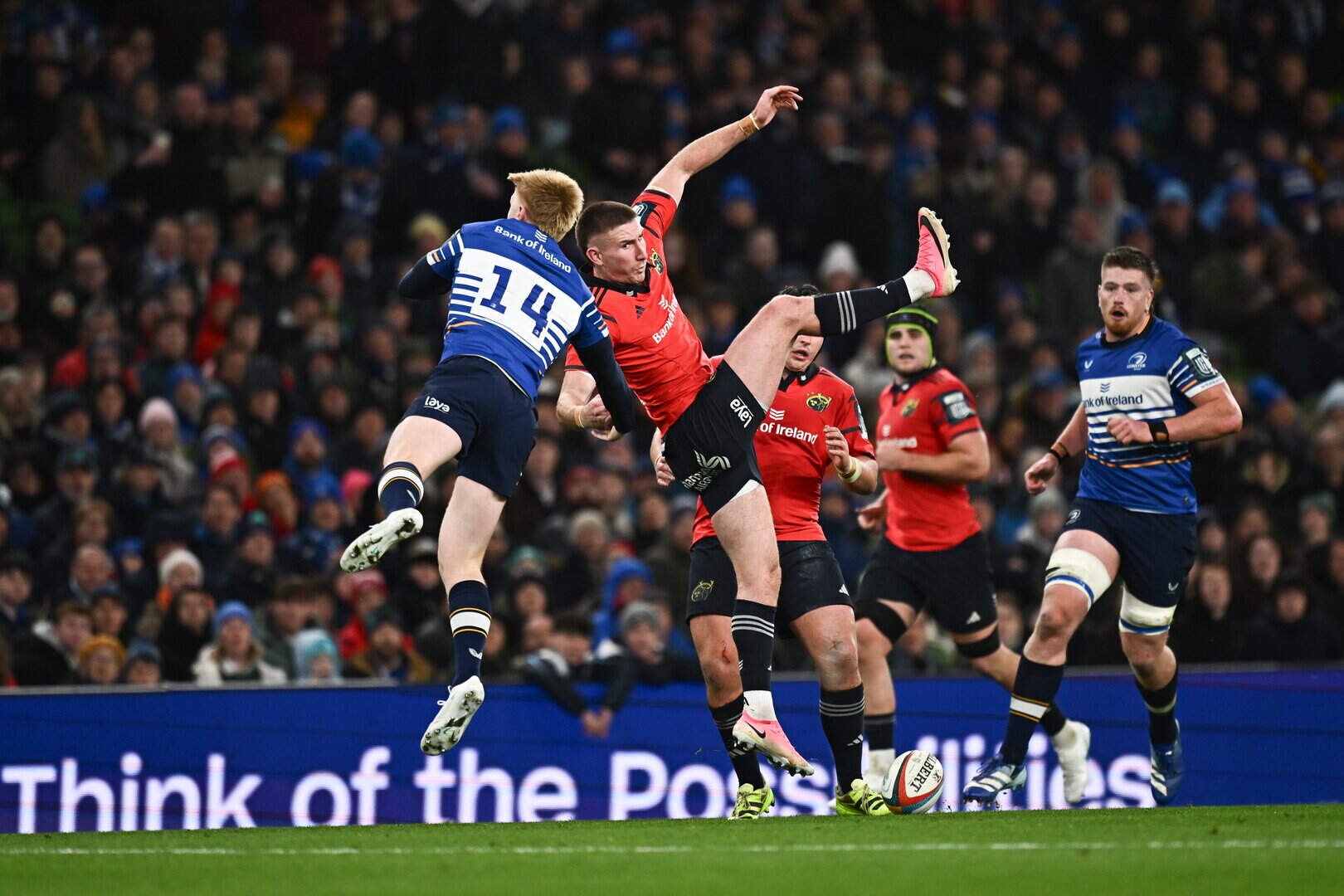 Ben O'Connor of Munster competes in the air with Leinster’s Tommy O'Brien during the URC match at the Aviva Stadium 