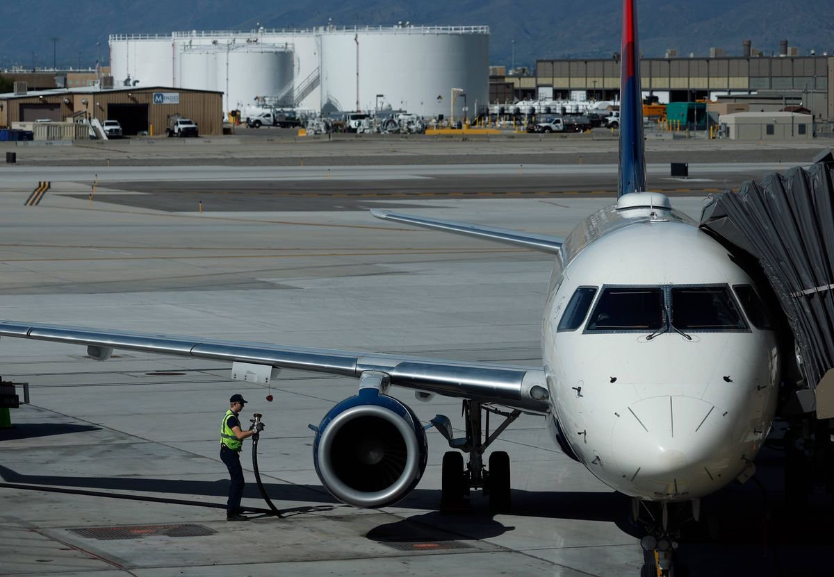 Worker fuels a Delta Airlines plane at Salt Lake City International Airport