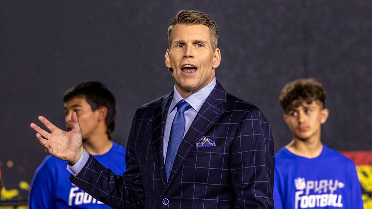 Scott Hanson stands at a podium introducing the Seattle Seahawks.