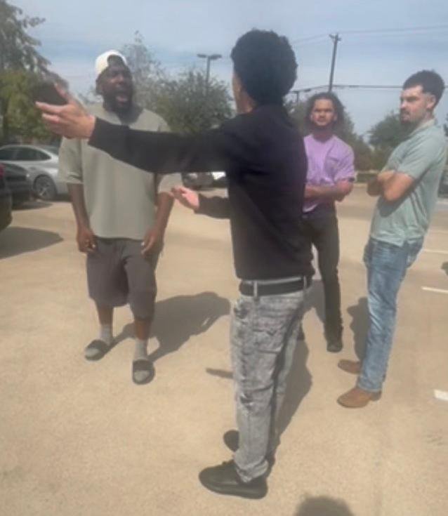 Dez Bryant arguing with a teenager in a parking lot.