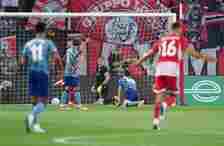 Aston Villa goalkeeper Emiliano Martinez sits dejected after Olympiakos' Ayoub El Kaabi scores the opener