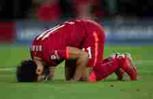 Mohamed Salah of Liverpool kisses the ground after scoring during the UEFA Champions League group B match between Liverpool FC and AC Milan at Anfi...