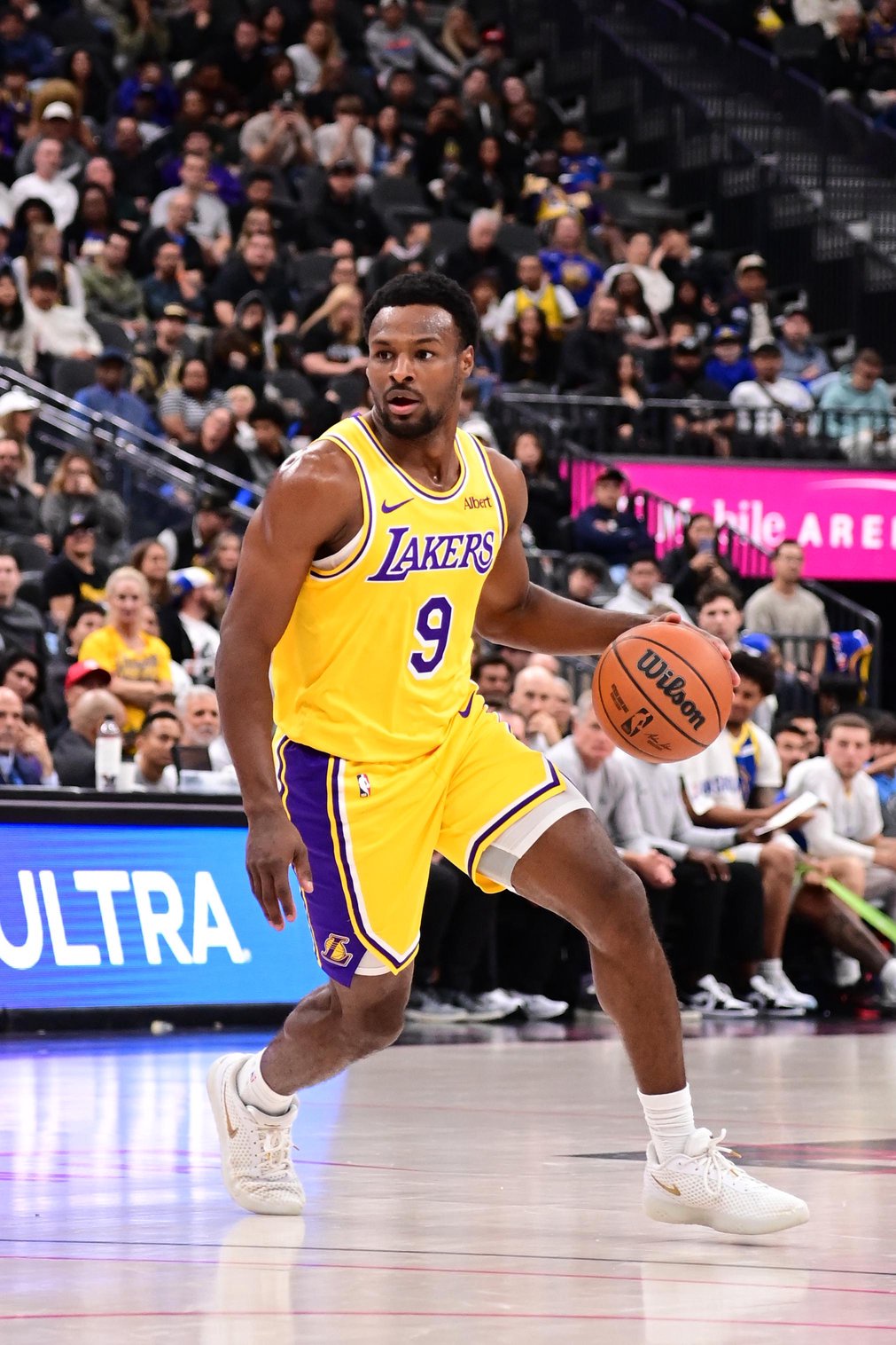 Los Angeles Lakers player Bronny James dribbles the ball during a game against the Golden State Warriors.