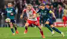 Konrad Laimer of FC Bayern Muenchen is challenged by Martin Odegaard of Arsenal FC during the UEFA Champions League quarter-final second leg match ...