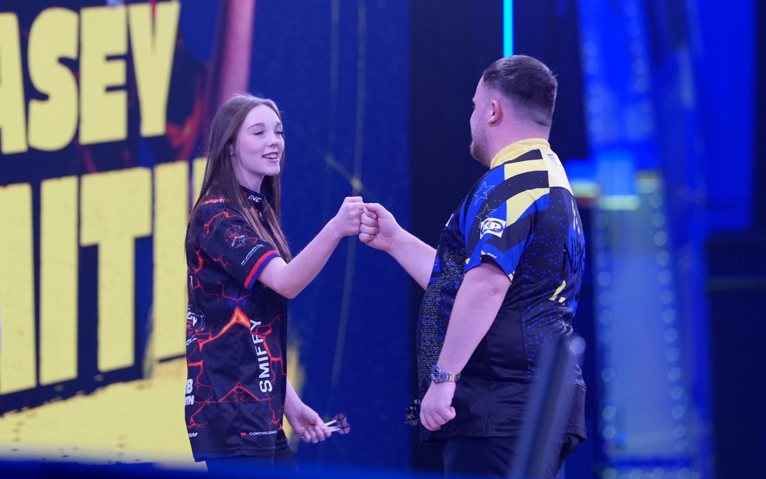 Kasey Smith (left) greets Luke Littler ahead of her leg