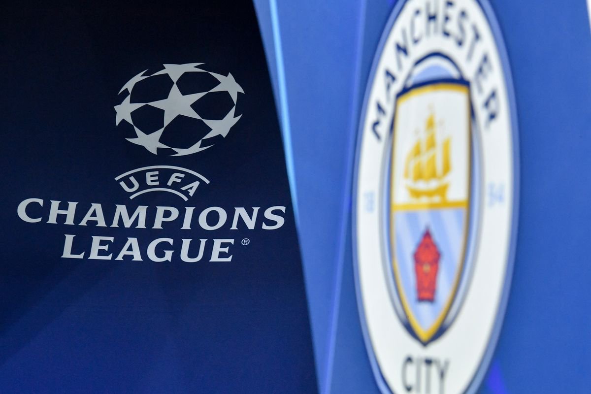 UEFA logo and Manchester City badge