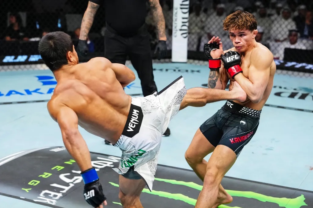 Ramazan Temirov of Uzbekistan kicks Lone’er Kavanagh of the United Kingdom in a flyweight fight during a UFC event.